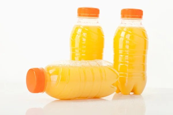 Orange juice bottles on white background,close up — Stock Photo, Image