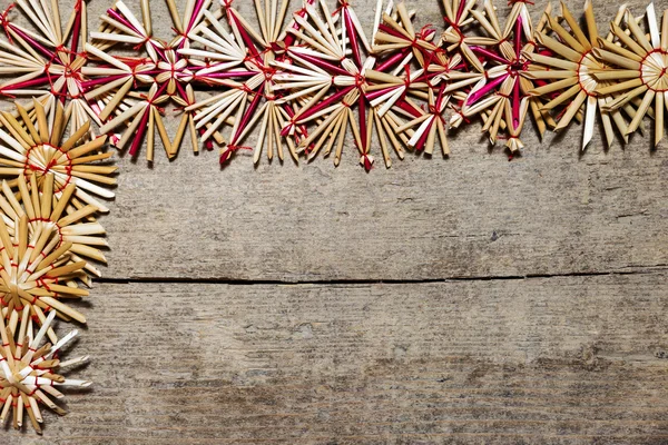 Frame of straw stars on wood, copy space — Stock Photo, Image