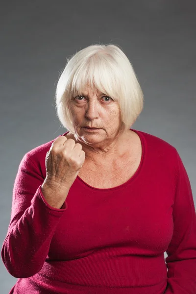 Showing fist, angry- female senior portrait — Stock Photo, Image