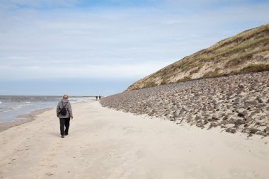 Almanya, East Frisia, Wangerooge, sahilde yürüyen kadın