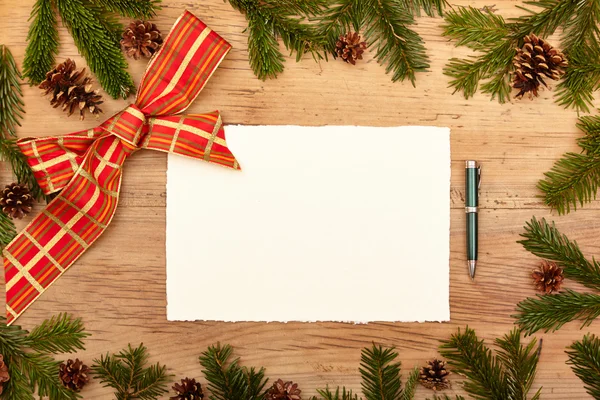 Blank card, ballpen, fir twigs and ribbon, on wood — Stock Photo, Image