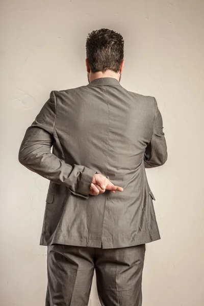 Business man from behind, crossing his fingers — Stock Photo, Image