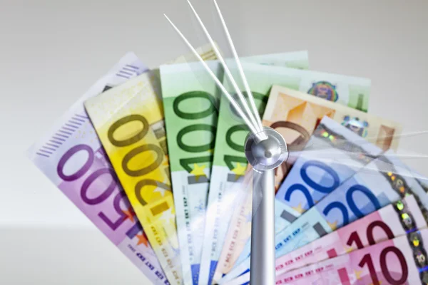 Spinning windmill in front of   euro notes — Stock Photo, Image