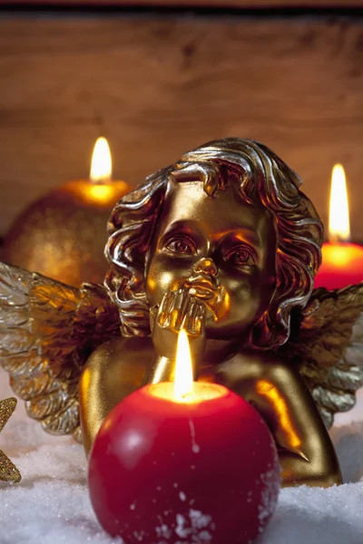Golden putto with burning candles — Stock Photo, Image