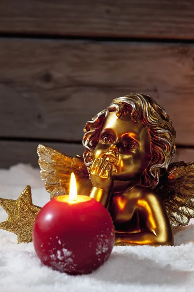 Golden putto with burning candle — Stock Photo, Image