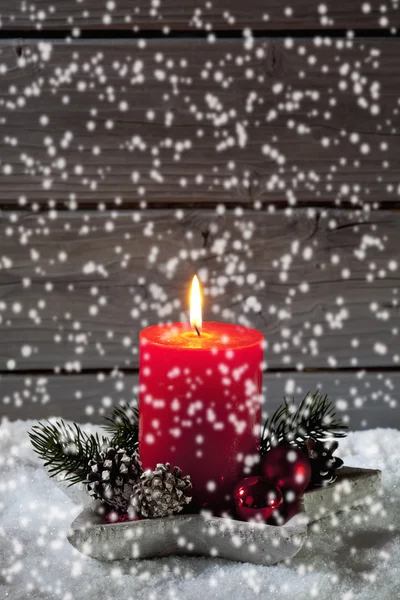 Snowfall with christmas candle — Stock Photo, Image