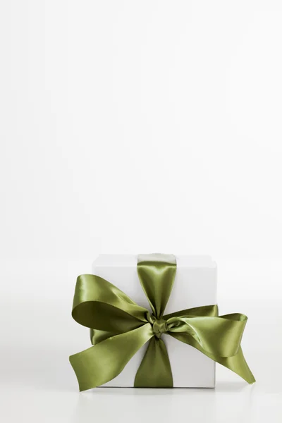 Christmas present with green bow — Stock Photo, Image