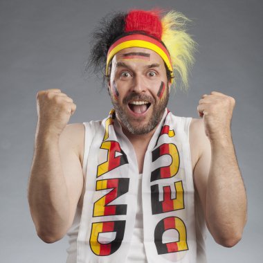 Ecstatic german soccer fan cheering clenching fists clipart