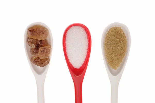 Spoons with different sugar — Stock Photo, Image