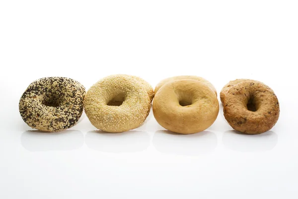 Bagels with poppy seeds bagels with sesame wholemeal bagels on white background — Stock Photo, Image