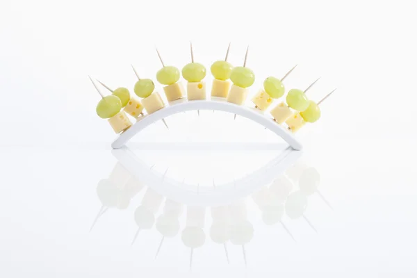 Cheese and grapes in tooth picks on white background — Stock Photo, Image