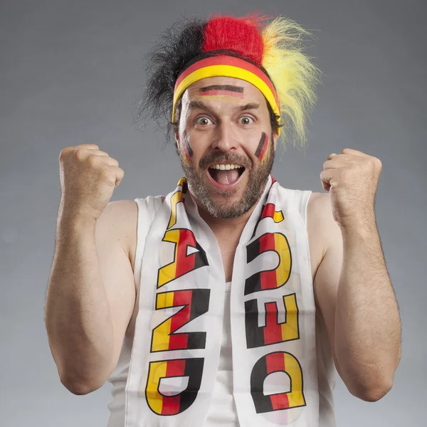 Ecstatic german soccer fan cheering clenching fists — Stock Photo, Image