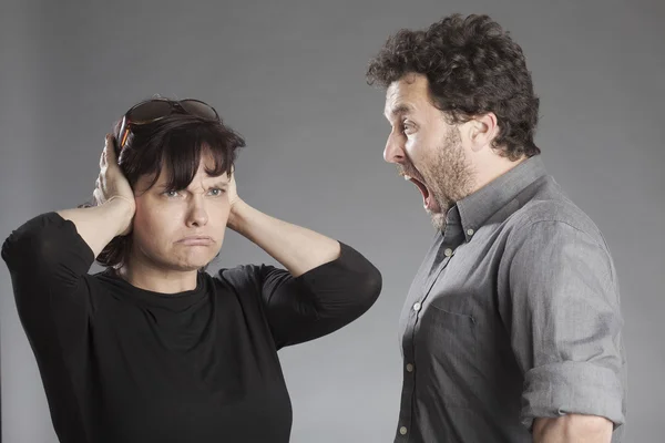 Mature couple quarreling man shouting woman covering ears — Stock Photo, Image