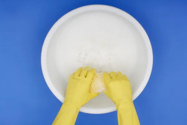 Hands wearing rubber gloves, Wringing out sponge — Stock Photo, Image