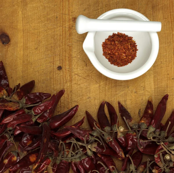 Pó de pimenta em argamassa com pimentas, close-up — Fotografia de Stock