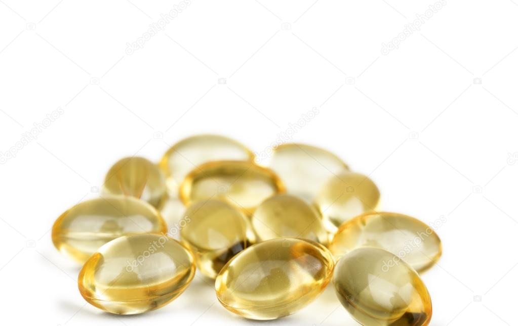 Gelatin capsules with fish oil on white background