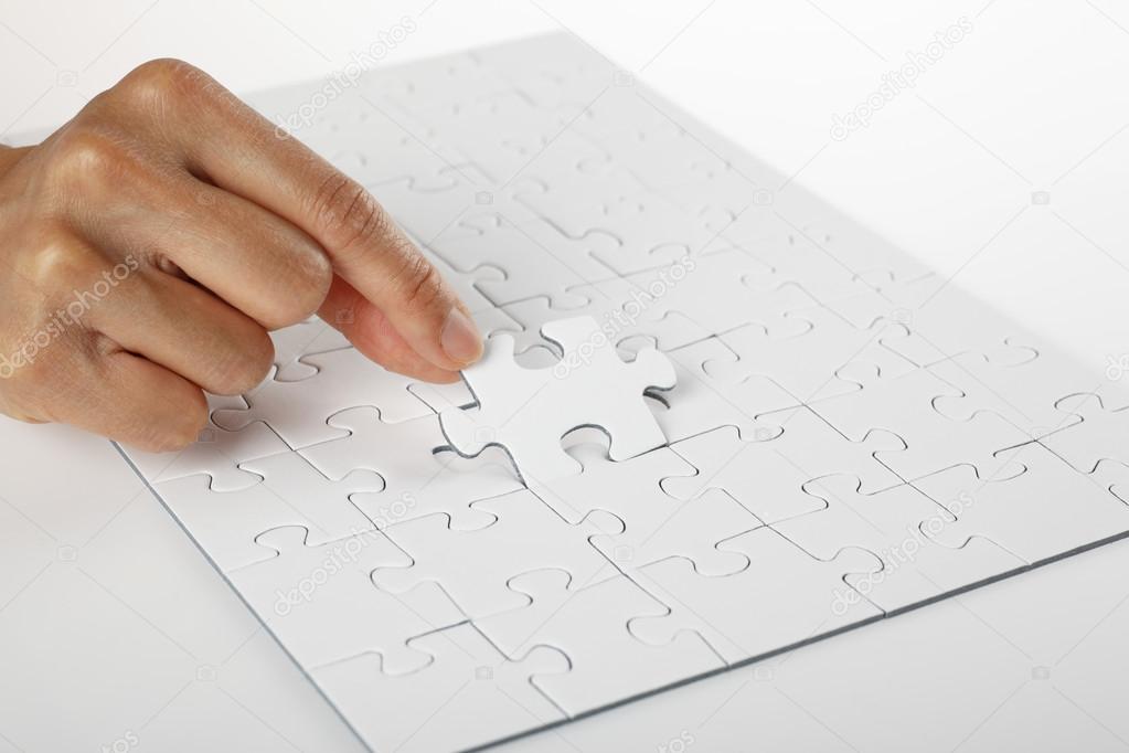 Hand finishing white puzzle