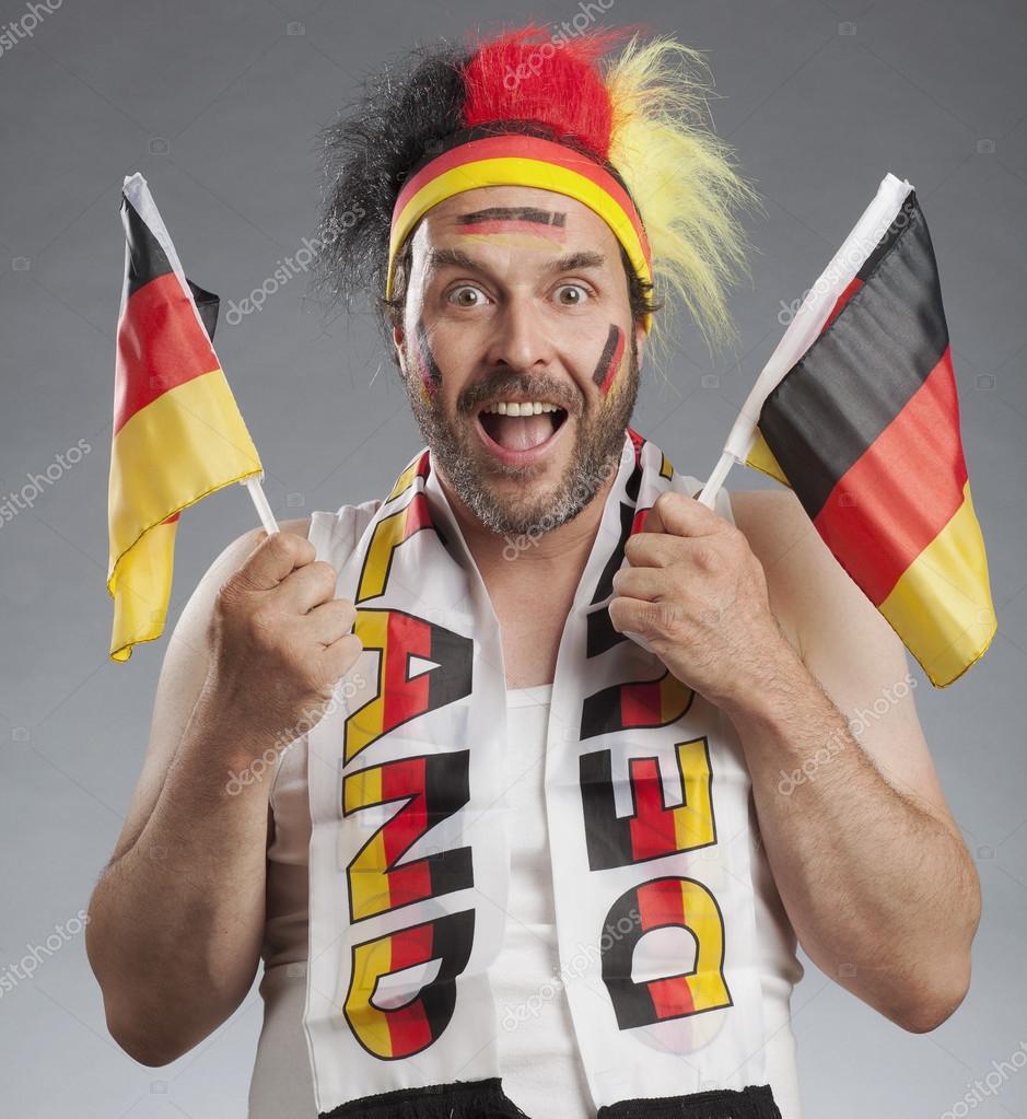 Ecstatic german soccer fan holding german flags in both hands — Stock
