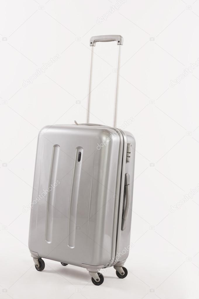 Silver suitcase with long handle against white background