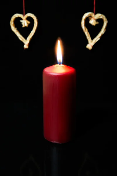 Red candle and straw hearts, — Stock Photo, Image