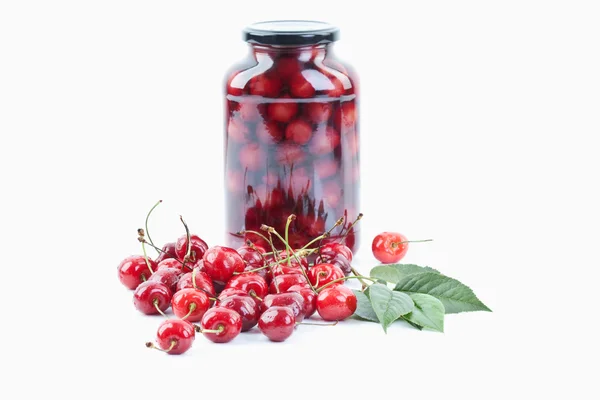 Cherries beside jar of cherry — Stock Photo, Image