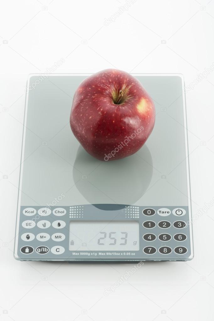 Fresh red apple on digital scales
