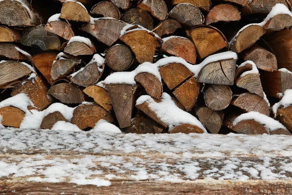 Wood pile with snow — Stock Photo, Image