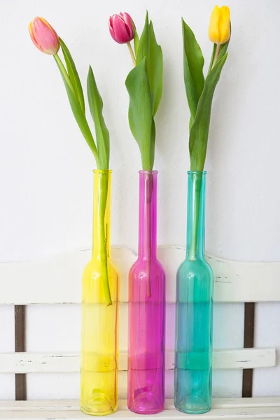 Three tulips in colourful  vases — Stock Photo, Image