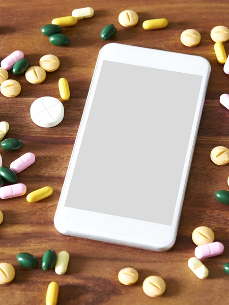 Smartphone with variety pills — Stock Photo, Image