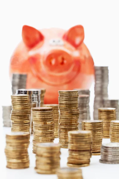 Piggy bank with piles — Stock Photo, Image