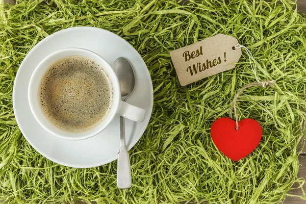 Coffee cup on artificial grass — Stock Photo, Image