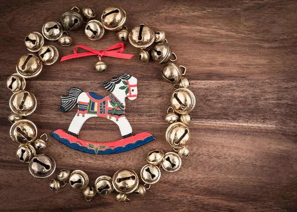 Bells in wreath and rocking horse — Stock Photo, Image