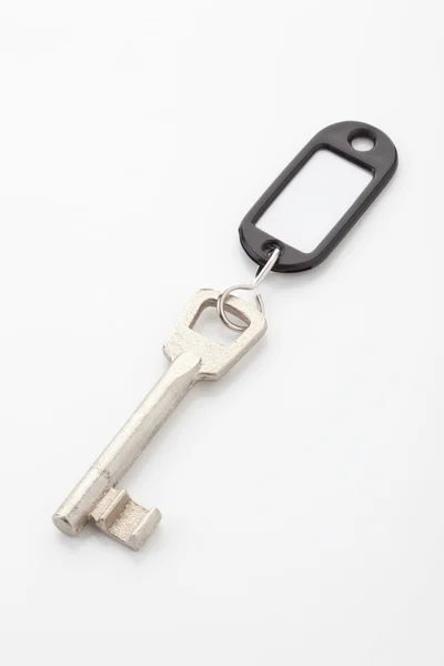 Key with key ring on white — Stock Photo, Image