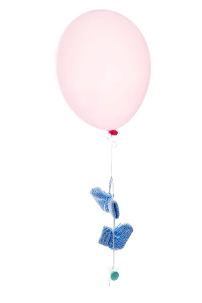 Pink balloon with baby socks — Stock Photo, Image