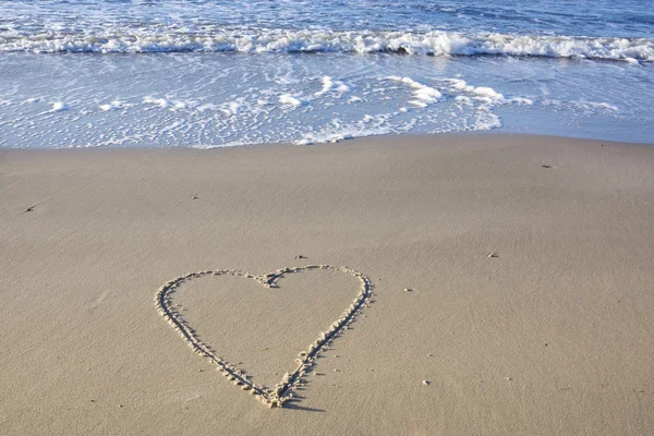 Heart in sand at beach Royalty Free Stock Images