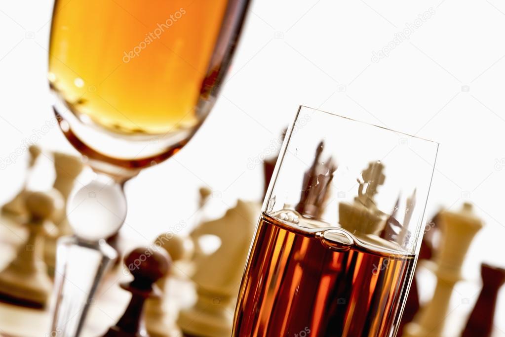 Sherry glasses in front of chess board