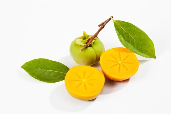 Kaki fruit with green leaves — Stock Photo, Image