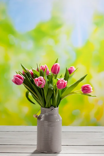 Bouquet of tulips in gray churn — Stock Photo, Image