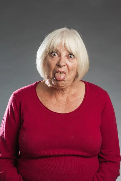 Female senior showing tongue — Stock Photo, Image