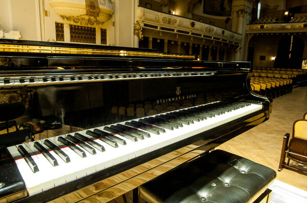 the grand piano is on the stage in a concert hall