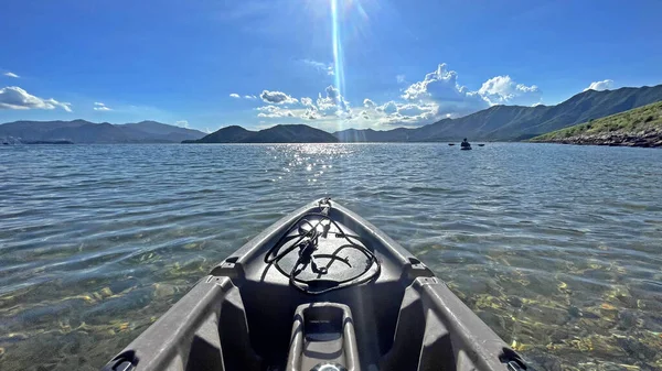 The landscape horizontal outdoor kayaking water sport adventure on the ocean with mountain and blue sky