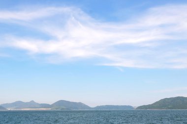 Sky, white clouds, sea and island
