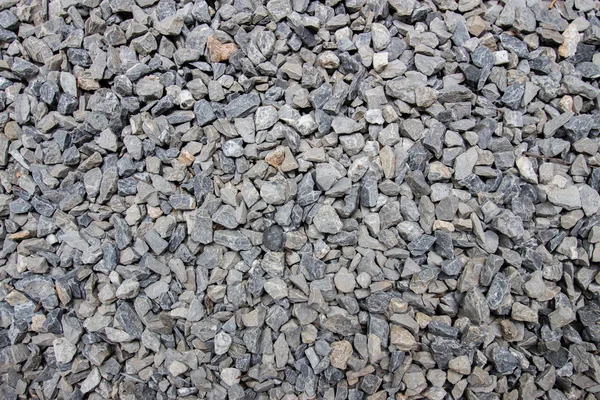 Bakgrund av svart och vit sten på marken — Stockfoto
