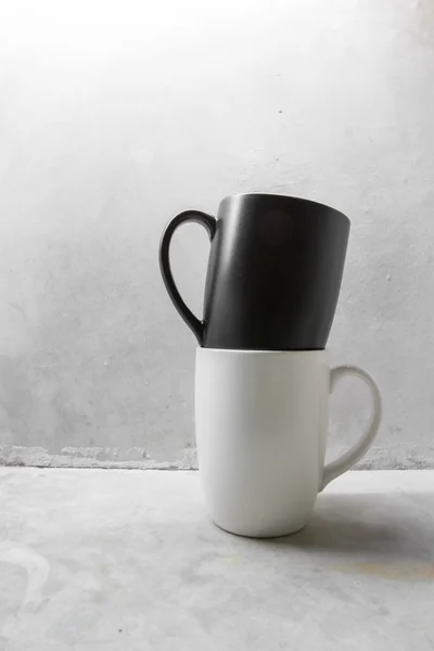 Black and white coffee mug on concrete table
