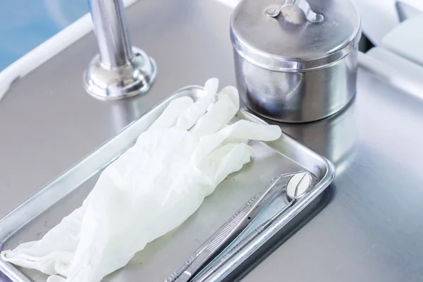 Dental equipment and white plastic glove — Stock Photo, Image