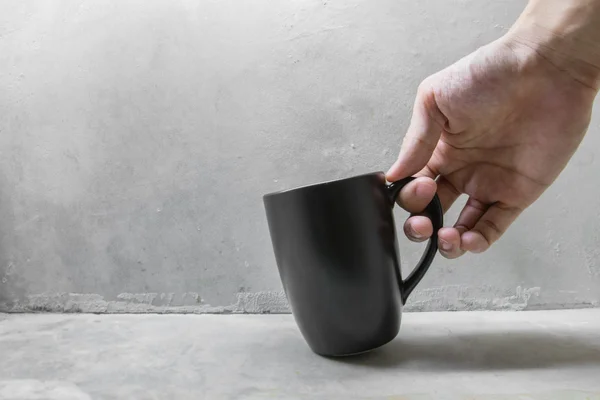 Рука тримає чорну чашку кави — стокове фото