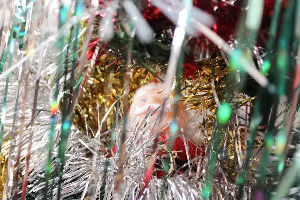 Santa Claus among tinsel — Stock Photo, Image