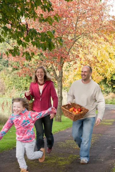 Parents walking outdoors with children — Stock Photo, Image