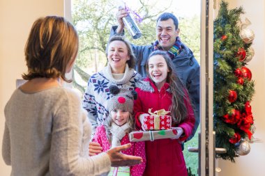 Family delivering presents at Christmas  clipart