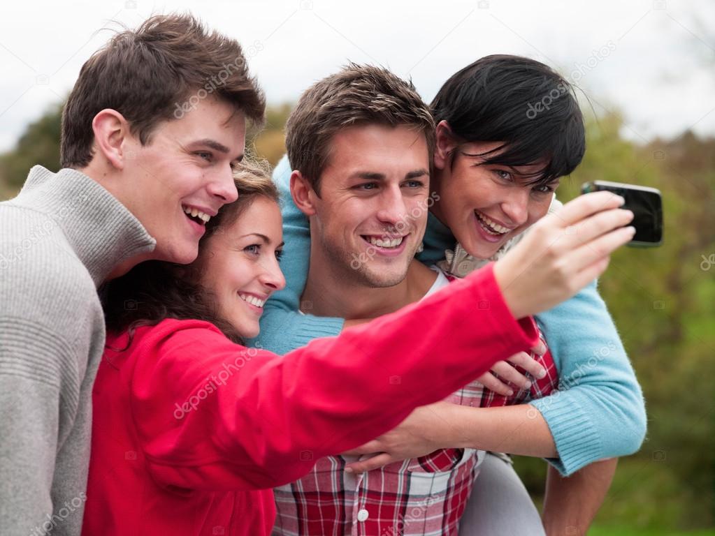 Four friends take a selfie outdoors